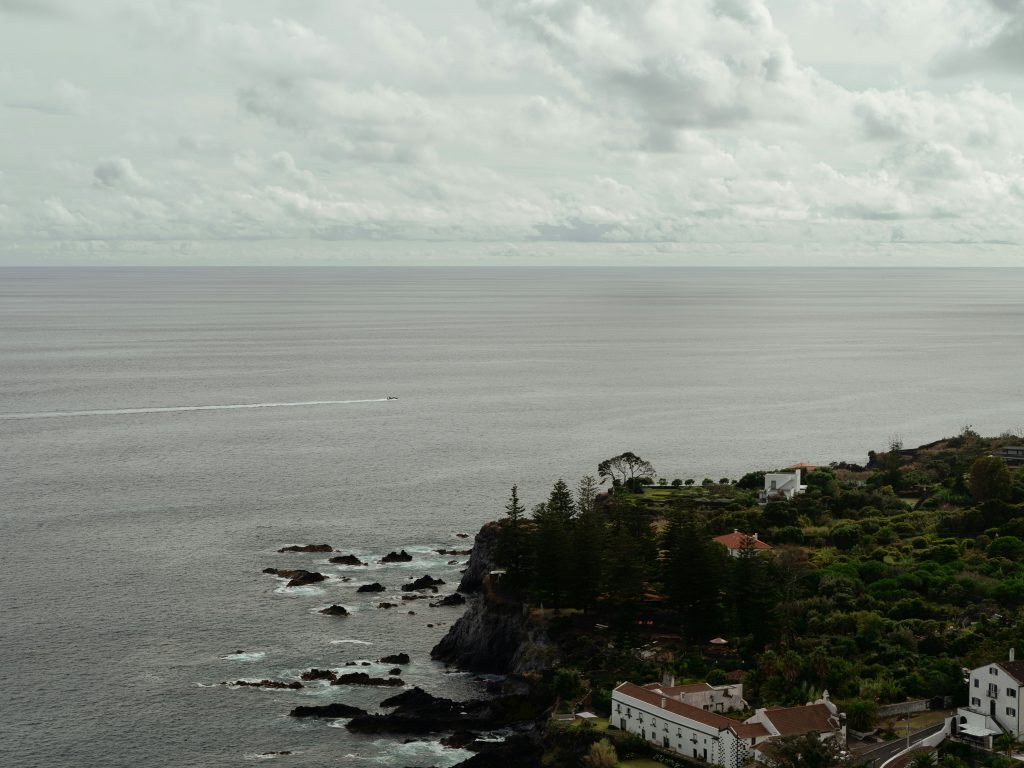 A boat crossing part of the atlantic ocean seen from the azores islands.