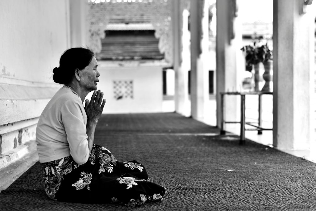 Woman sitting and praying